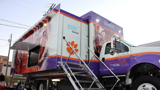 The Joseph F. Sullivan Center, the university's health care center, has opened the world's first solar-powered, mobile health clinic. When parked, the mobile clinic's slide out nearly doubles its interior space, and it features a television screen that will deliver nutritional and health education to patients.