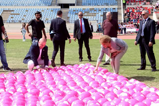  First Lady Mrs. Nadia Aoun and Minister of Health Mr. Ghassan Hasbani placing last two balls inside the ribbon.